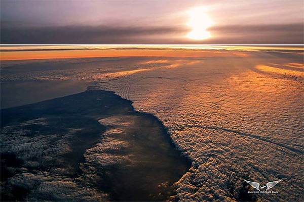 On this photo over the U.K., the white line is level with the horizon in the middle left, and there is obvious curvature on both the left and right side of the horizon.