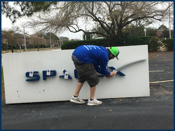 Flat Earth Zealot Nathan Thompson Fake Pees On SpaceX Sign, Drops F Bomb
